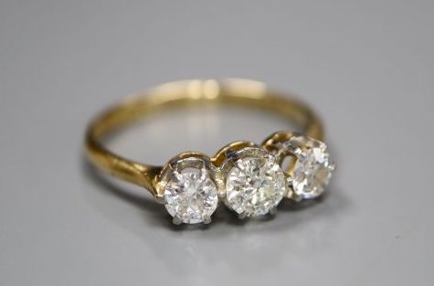 An 18ct and plat, three stone diamond ring, size O, gross 2.7 grams.